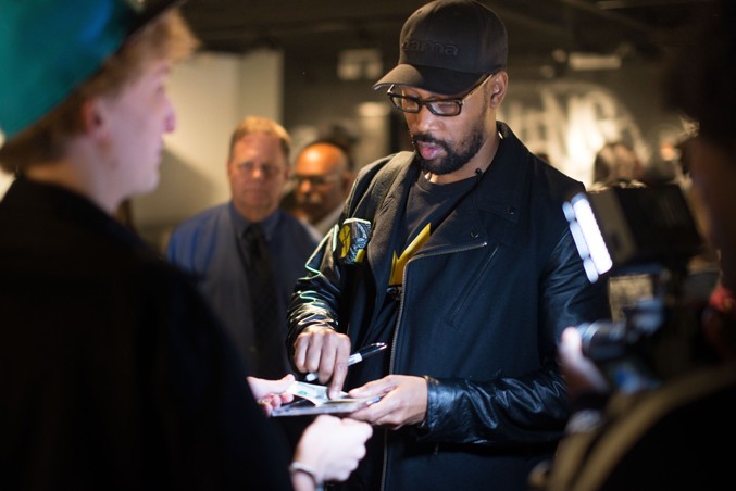 RZA from the Wu-Tang Clan signing autographs during the Living Like Kings opening reception.